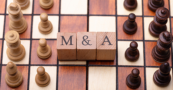 Wooden Blocks With Mergers And Acquisitions Text On Chess Board